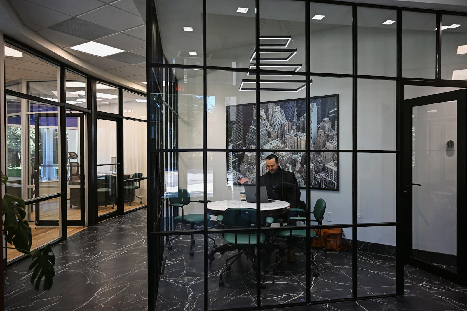 A modern office with a person working at a table